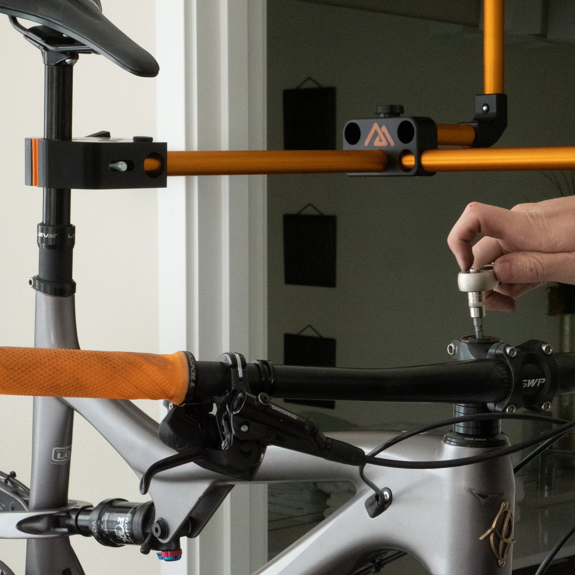The Hangar hangs from any standard door frame, allowing you to easily work on your bike