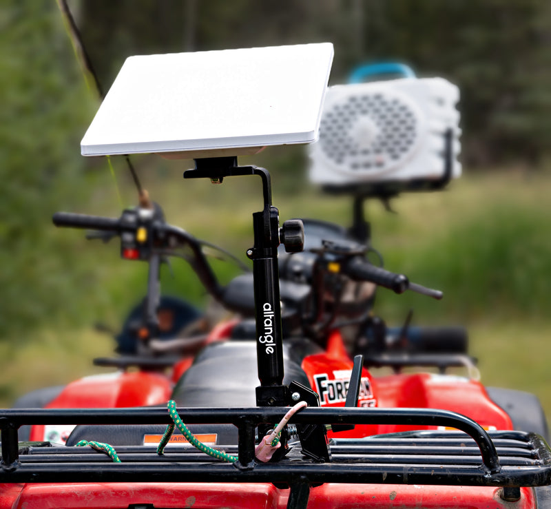 Hub clamped to a truck bed rail with a hunting rifle in an Arca plate, predawn light