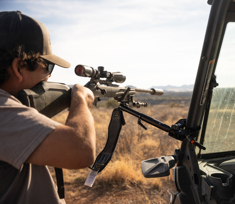 Hub clamped to a UTV roll cage with a spotting scope on top