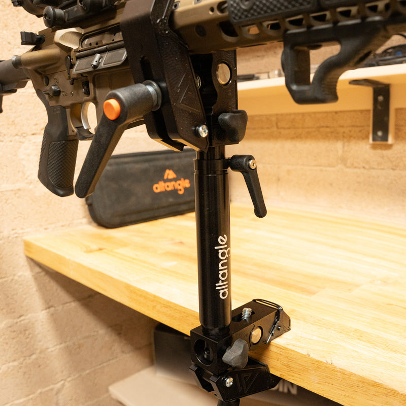 Connect Pro clamped to a workbench holding a rifle