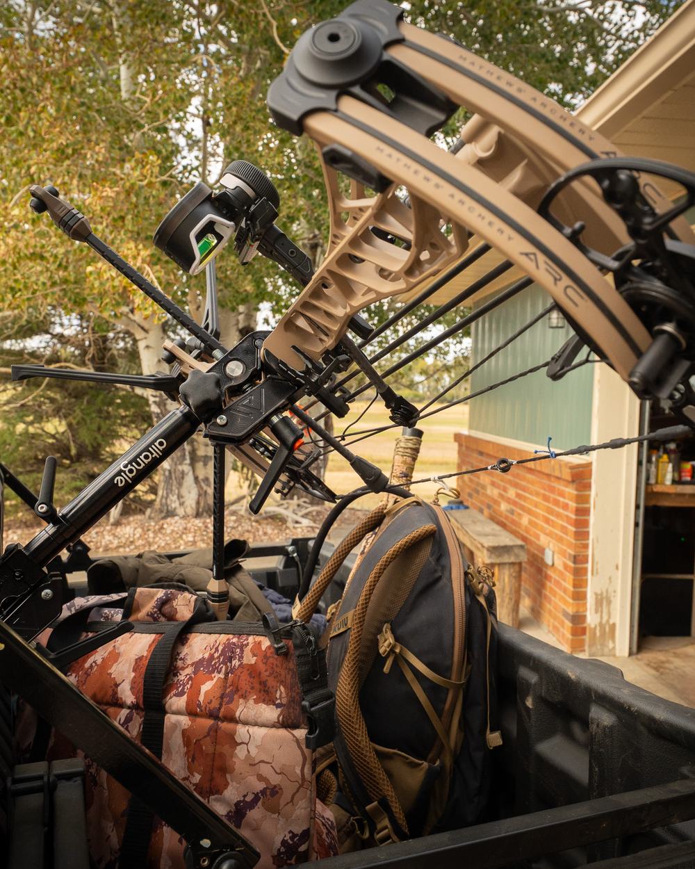 Compound bow held by Connect Pro clamped to a side-by-side cage
