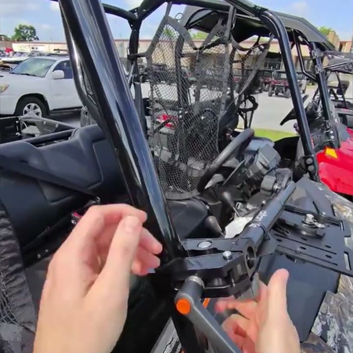Hands seating the Connect clamp on a roll cage tube