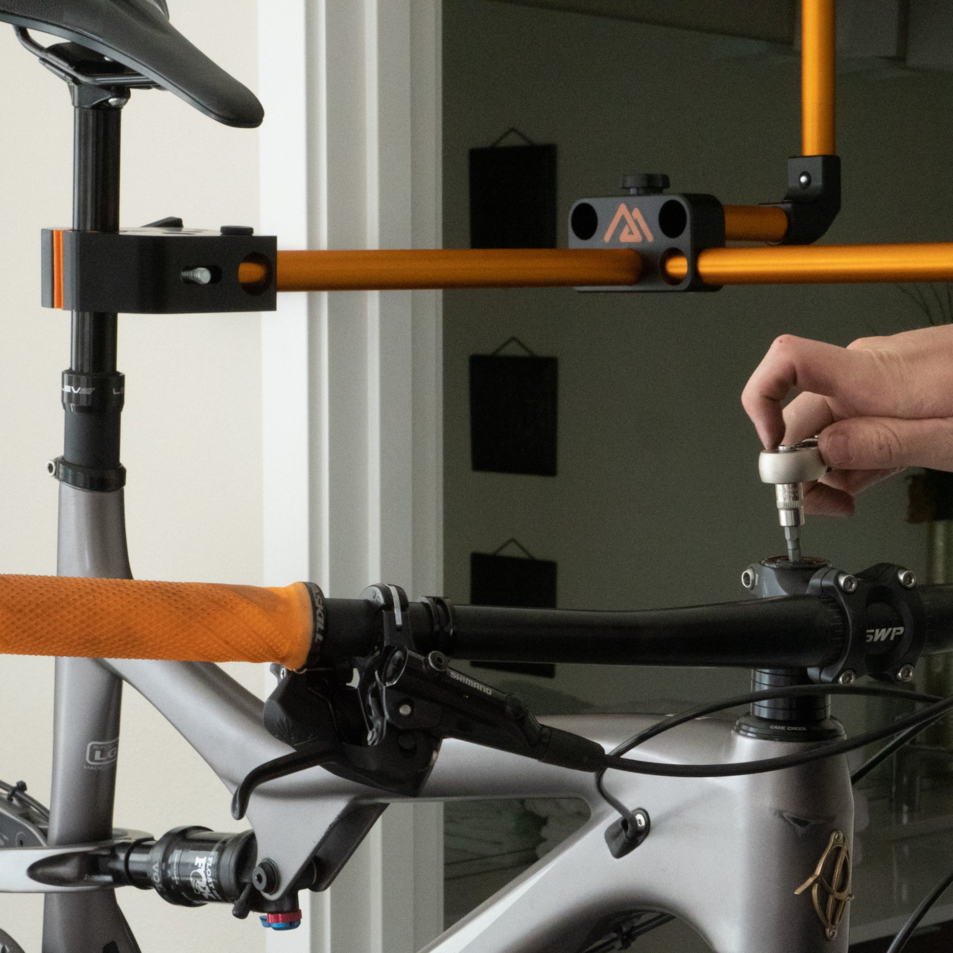 The Hangar hangs from any standard door frame, allowing you to easily work on your bike 